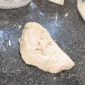 Shaping a piece of dough into a ball